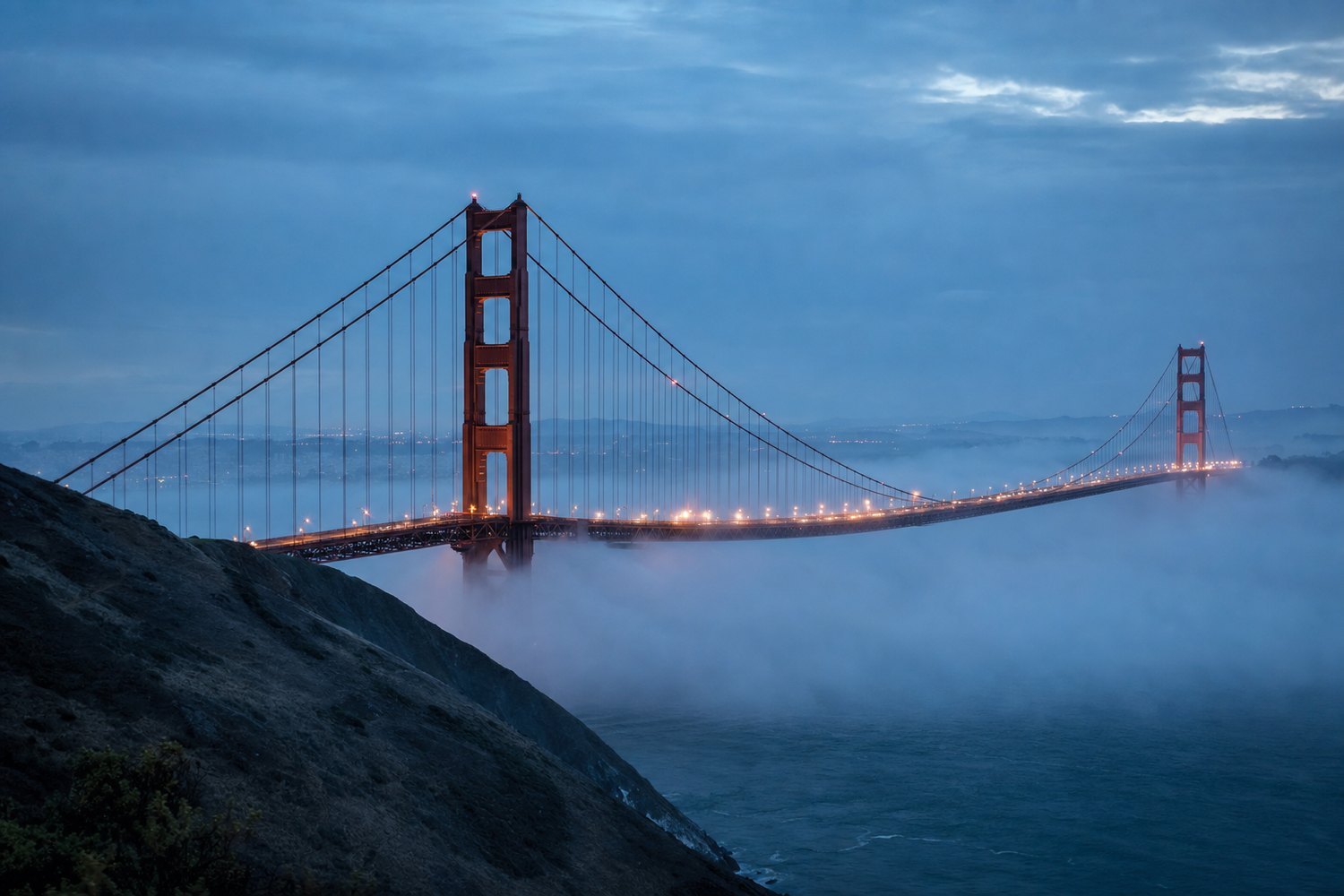 Golden Gate Bridge in fog at blue hour